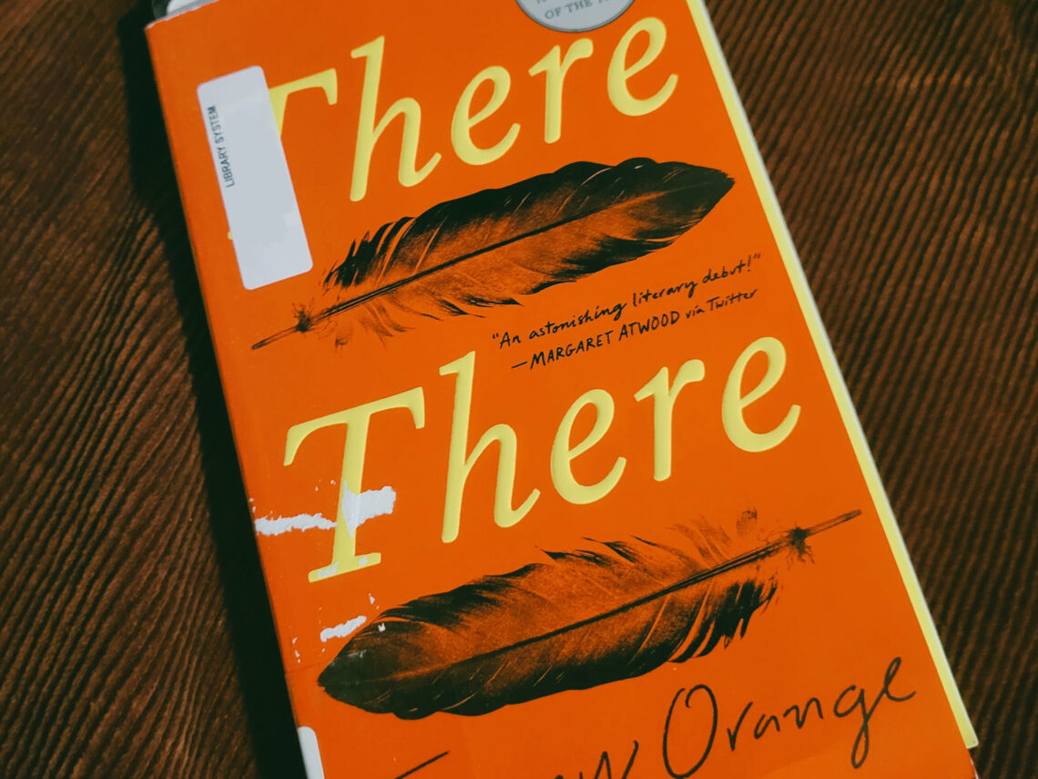 A close-up of a library copy of "There There" by Tommy Orange, with some light damage to the cover.