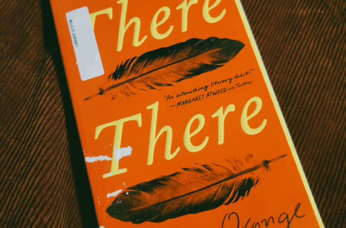 A close-up of a library copy of "There There" by Tommy Orange, with some light damage to the cover.